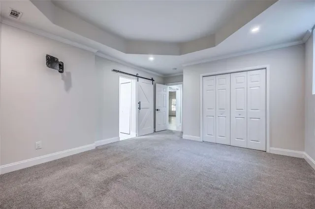 a bathroom with a granite countertop toilet sink and mirror