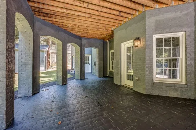 a view of a brick house with a large window