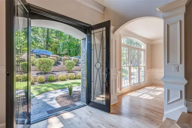 a view of backyard with large windows and wooden floor