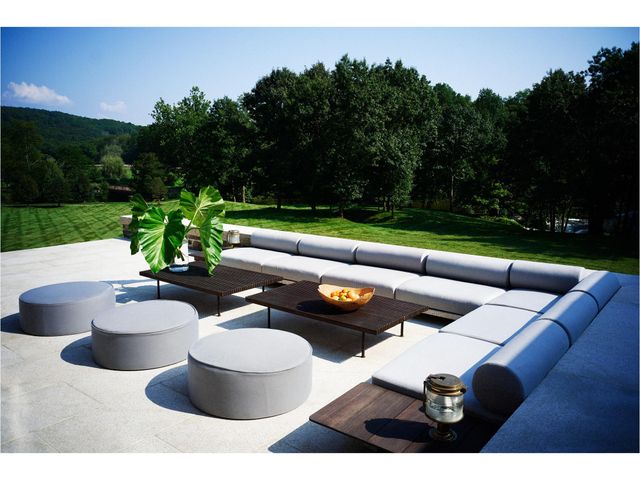 a view of a patio with couches chairs and potted plants