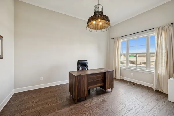 a large white kitchen with lots of counter space wooden floor and appliances