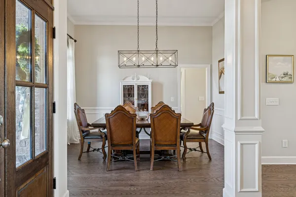 a large white kitchen with kitchen island a sink a center island stainless steel appliances and a center island