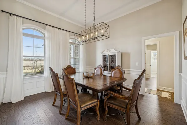 a kitchen with stainless steel appliances granite countertop a stove a white cabinets and a sink