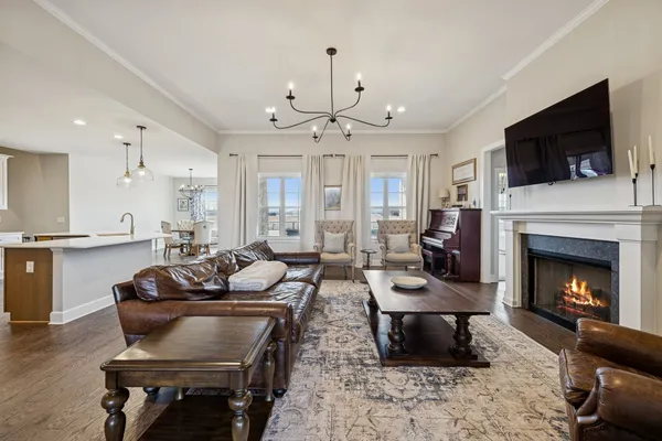 a bedroom with a large bed and a chandelier