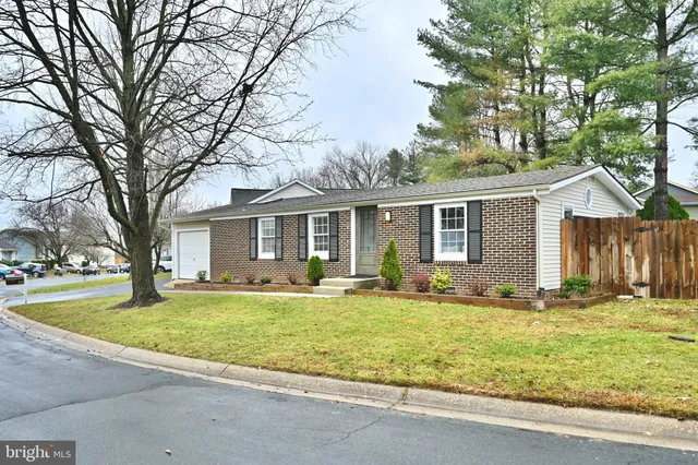 a view of a house with a yard and trees