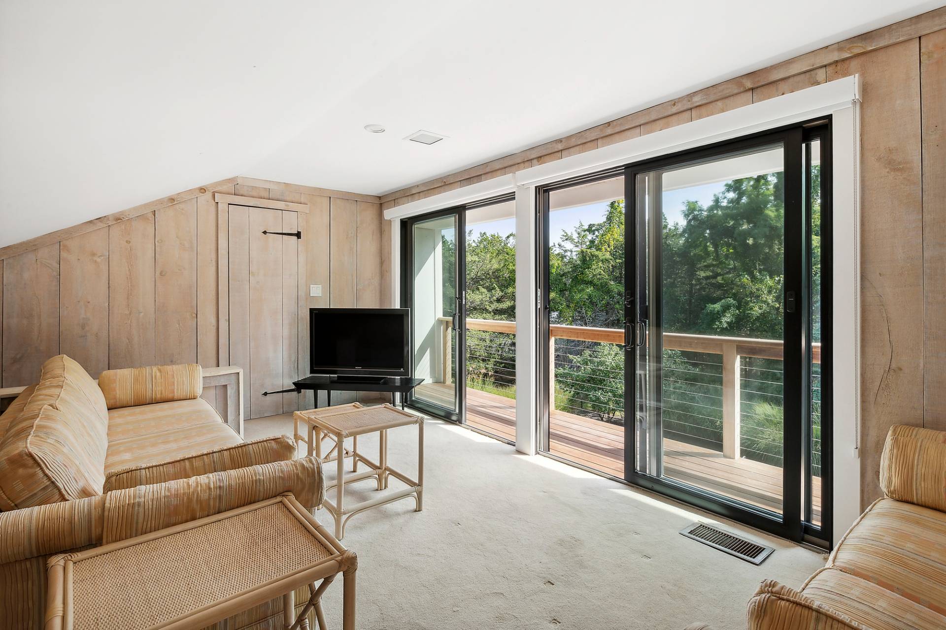 1 Ward Road Shelter Island, NY 11964 - Photo 16 of 17 a living room with furniture a flat screen tv and a floor to ceiling window