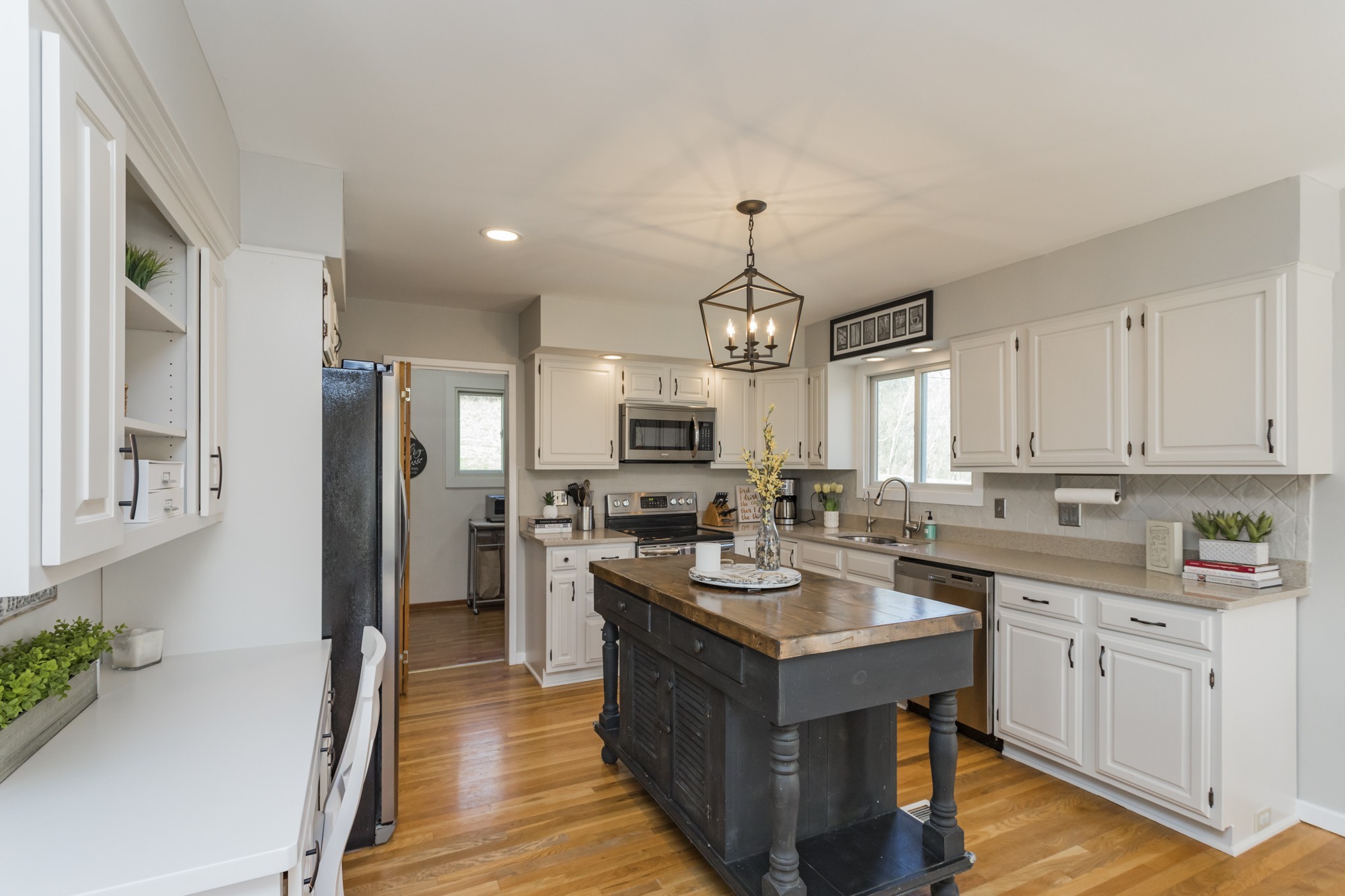 804 High Point Ridge Road Franklin, TN 37069 - Photo 14 of 50 a kitchen with a refrigerator a sink dishwasher a oven with white cabinets and wooden floor