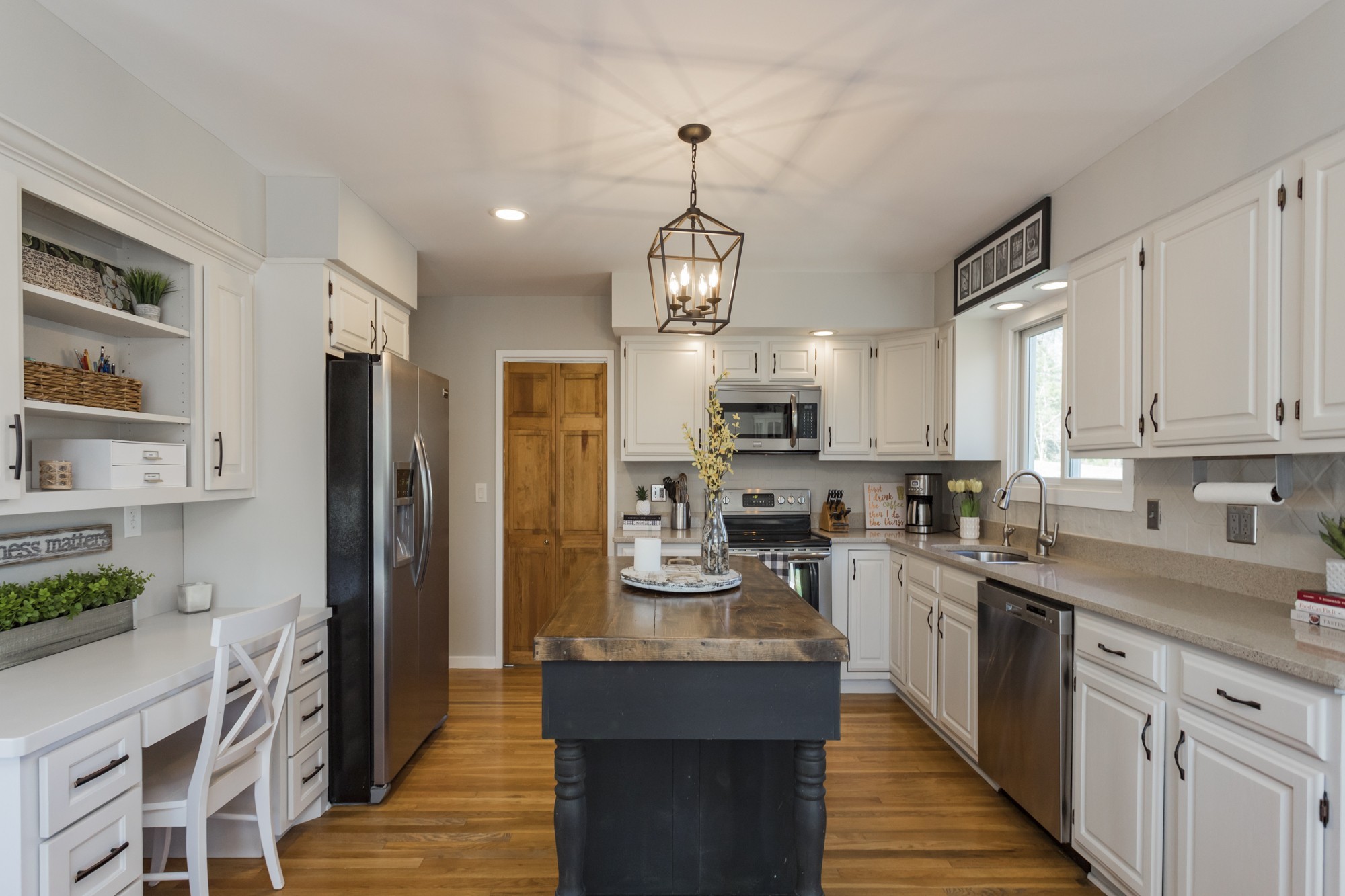 804 High Point Ridge Road Franklin, TN 37069 - Photo 15 of 50 a kitchen with stainless steel appliances granite countertop a refrigerator a stove top oven a sink dishwasher and white cabinets with wooden floor