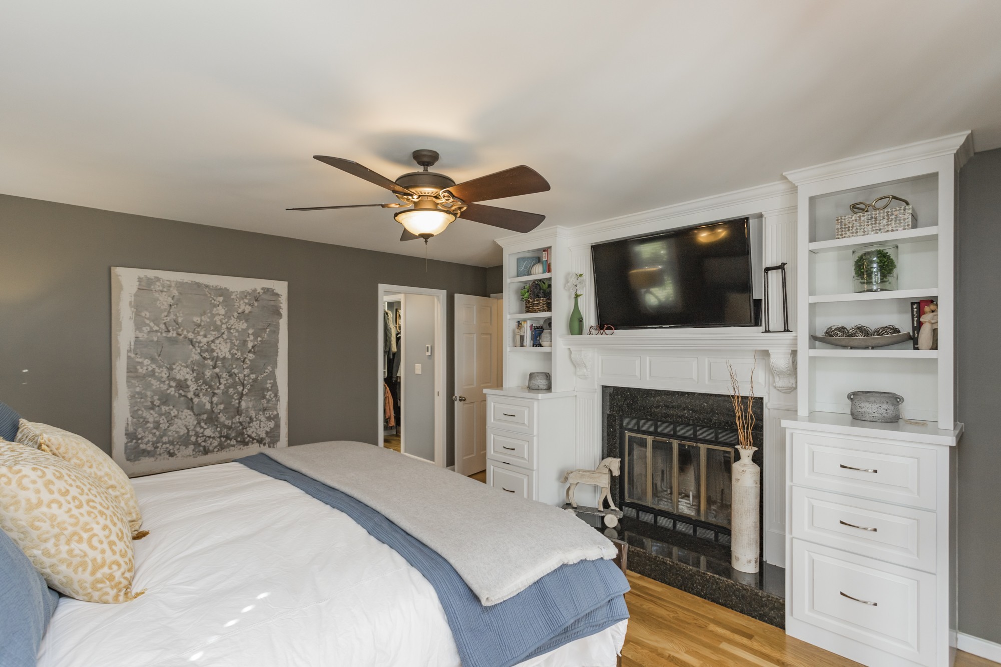 804 High Point Ridge Road Franklin, TN 37069 - Photo 23 of 50 a bedroom with a large bed a flat tv screen and a fireplace