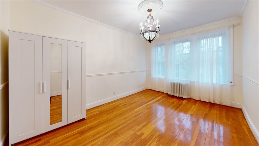 311 Tappan Street, Unit 3 Brookline, MA 02445 - Photo 21 of 35 a view of a room with wooden floor chandelier and a window