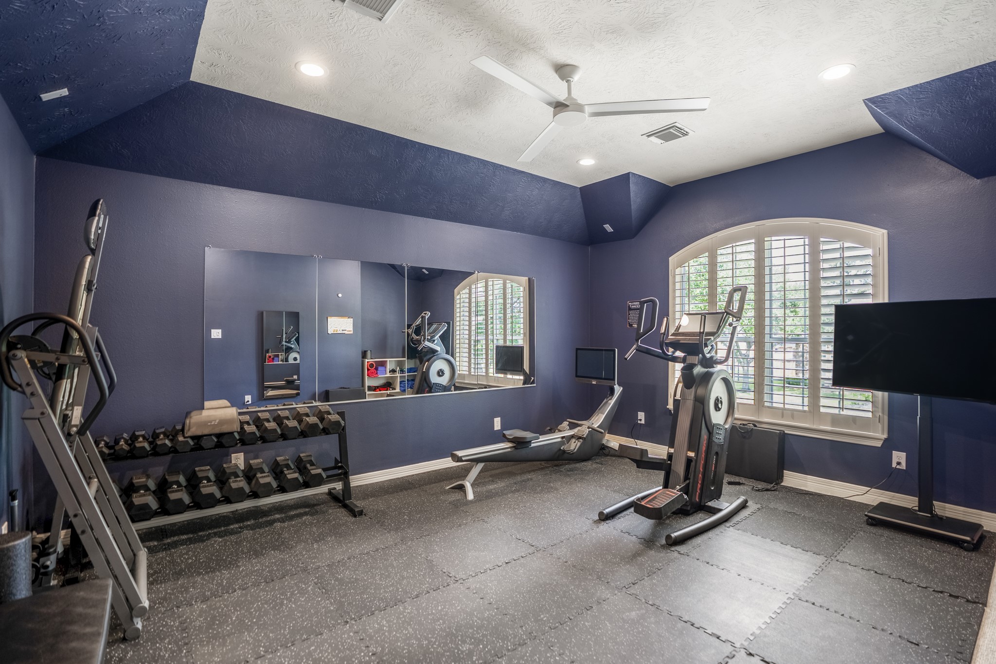9707 Blue Cruls Way Spring, TX 77379 - Photo 38 of 50 a room with gym equipment and a large window