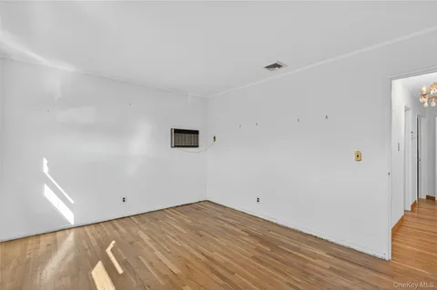 a view of a room with wooden floor