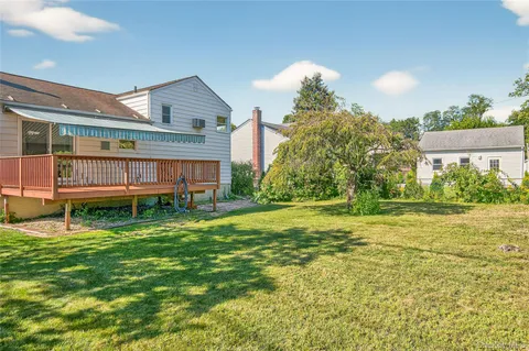 a view of a house with a yard and sitting area