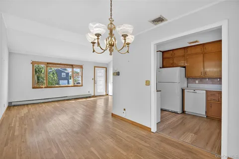 a view of a room with wooden floor cabinet and windows