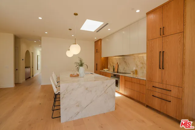 a kitchen with stainless steel appliances granite countertop a sink and cabinets