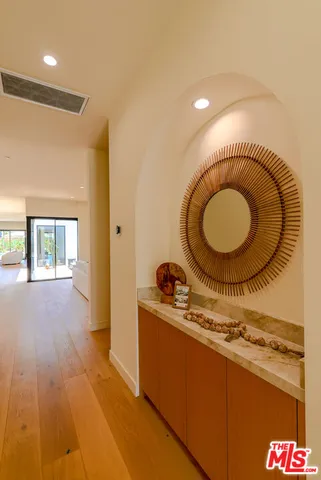 a living room with furniture a rug and a clock