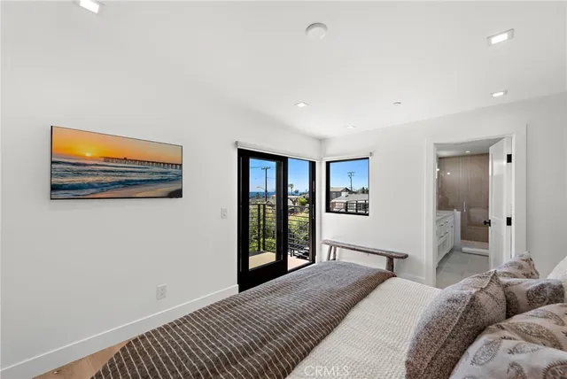 a spacious bedroom with a bed and a large window