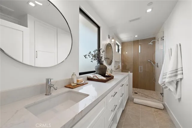 a bathroom with a double vanity sink and a mirror
