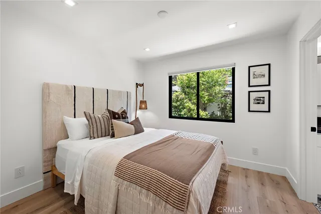 a bedroom with a large bed and a window