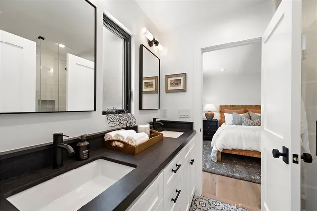 a bathroom with a double vanity sink and mirror