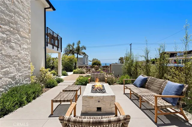 a view of a patio with couches table and chairs and potted plants