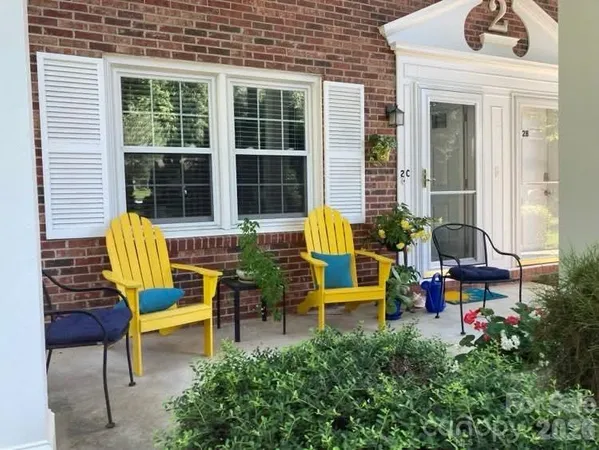 a bench is sitting in front of house and outdoor seating
