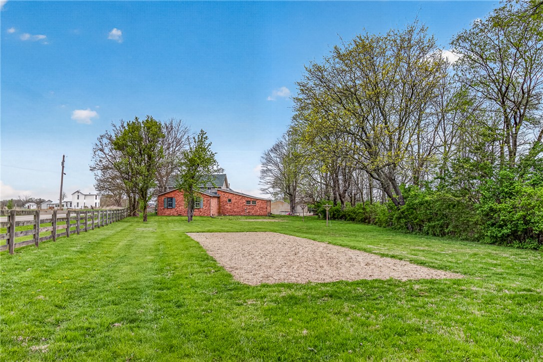 8700 Quaker Trace Road Camden, OH 45311 - Photo 27 of 34 Expansive green space with a sandbox, offering recreational possibilities.