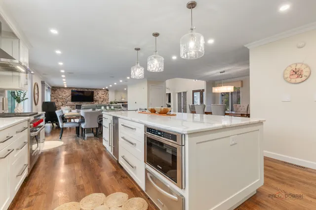a kitchen with a stove and a view of kitchen