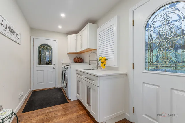 a kitchen with a stove a sink and a window