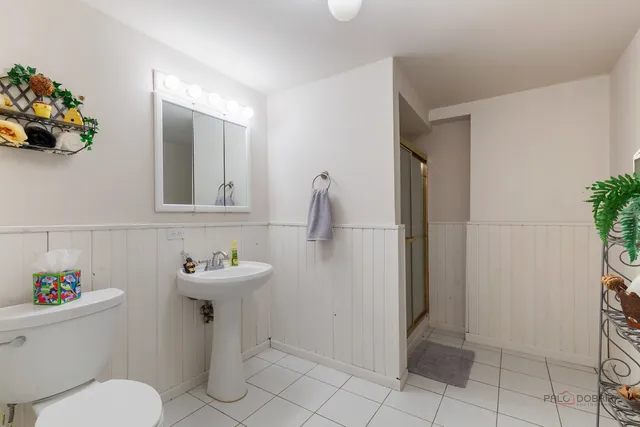 a bathroom with a sink mirror and toilet