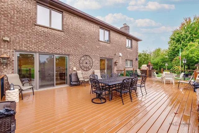 a view of a dinning table and chairs in patio of the house