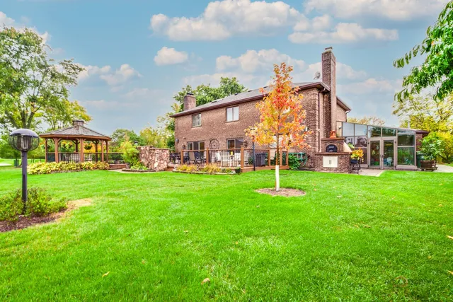 a view of a big yard with a house in the background