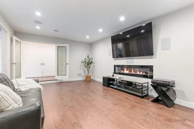 a living room with furniture a flat screen tv and a window