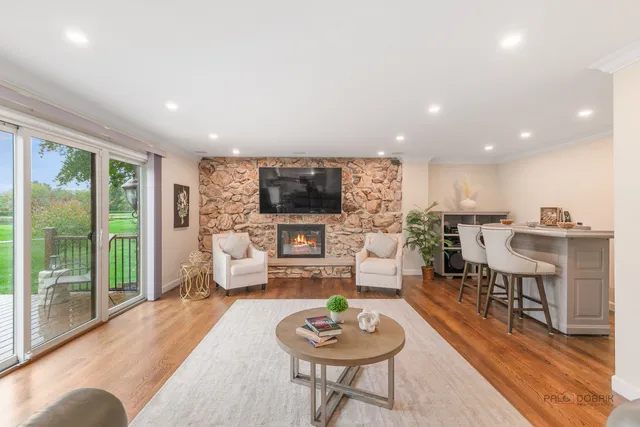 a living room with furniture a rug and a flat screen tv