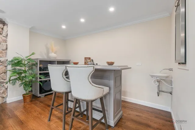 a dining room with furniture and wooden floor