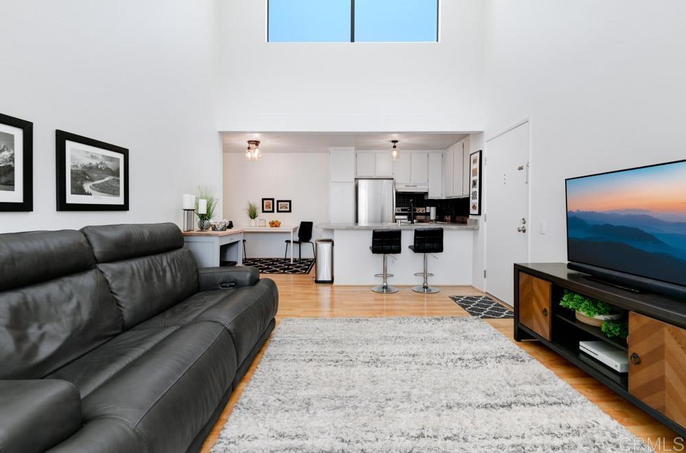 3579 Ruffin Road, Unit 208 San Diego, CA 92123 - Photo 1 of 1 a living room with furniture and a flat screen tv