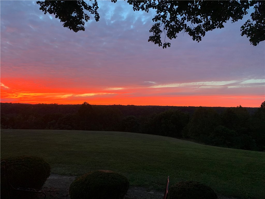 5669 O Neall Road Waynesville, OH 45068 - Photo 3 of 72 The dramatic sunset paints the sky in vibrant hues over the serene landscape.