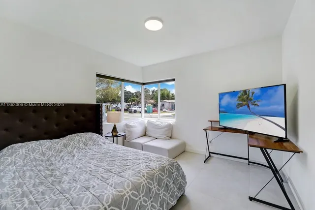 a bedroom with a bed and window