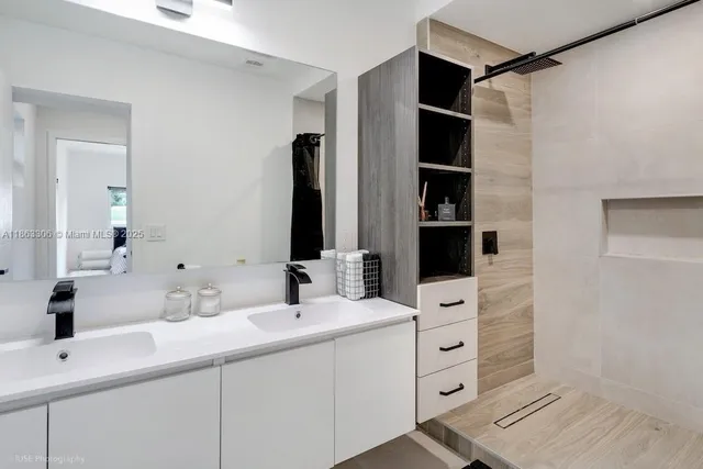a bathroom with a double vanity sink and mirror