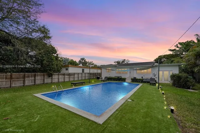 a view of a backyard with sitting area