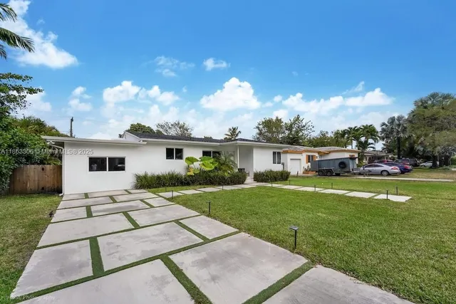 a front view of a house with garden
