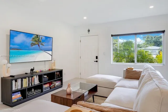 a living room with furniture and a flat screen tv