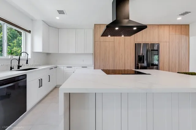 a kitchen with a sink a counter space and cabinets