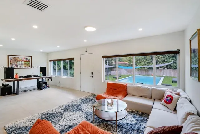 a living room with furniture and a large window