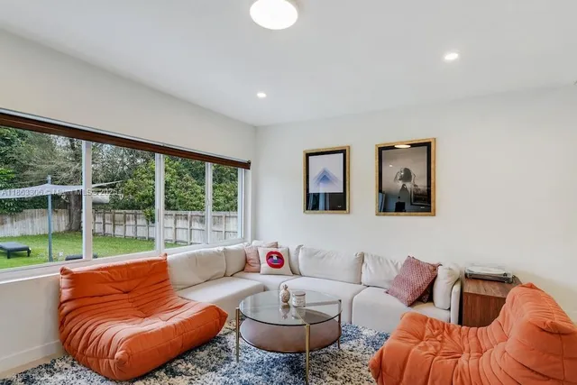 a living room with furniture and a large window