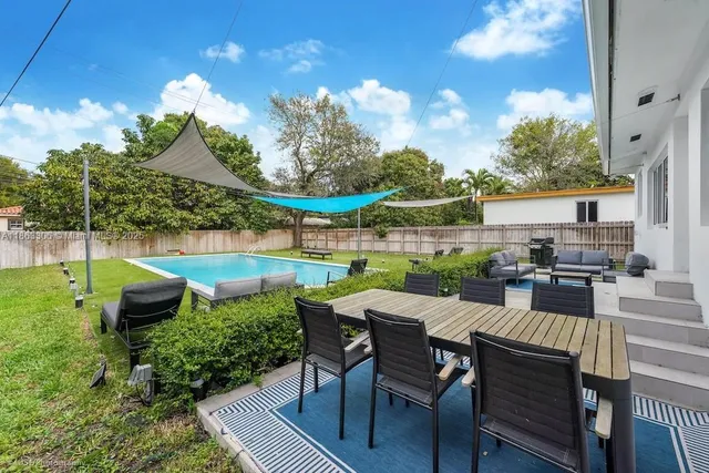 a view of a patio with table and chairs potted plants with wooden floor