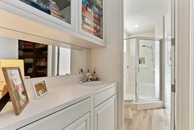 a spacious bedroom with a bed and a flat screen tv