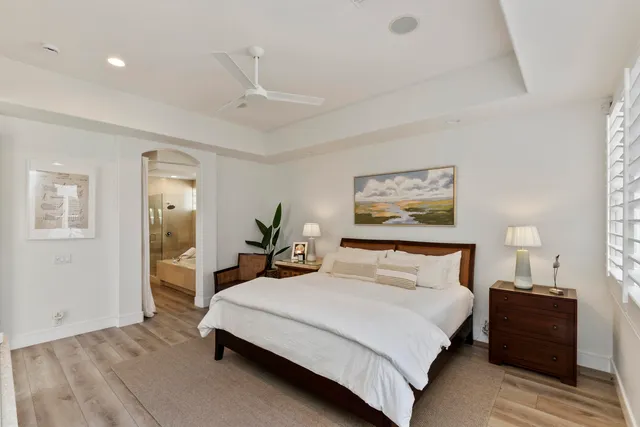a large white kitchen with a large window