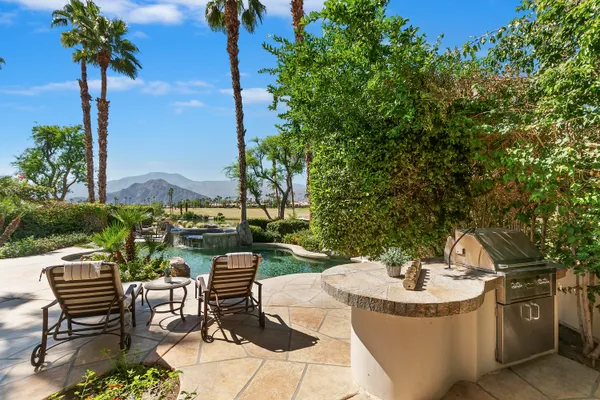 a view of a swimming pool and lounge chairs