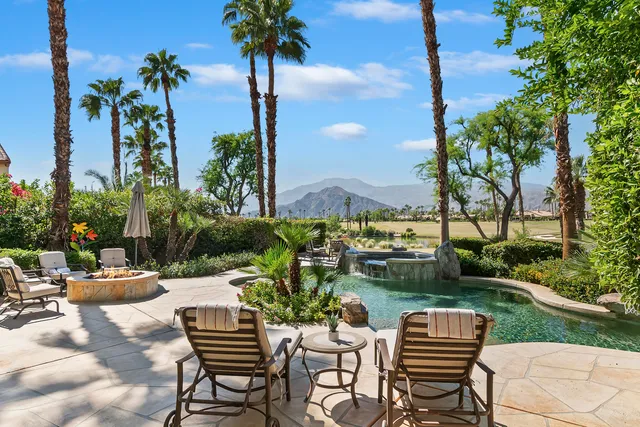 a view of a house with backyard sitting area and swimming pool